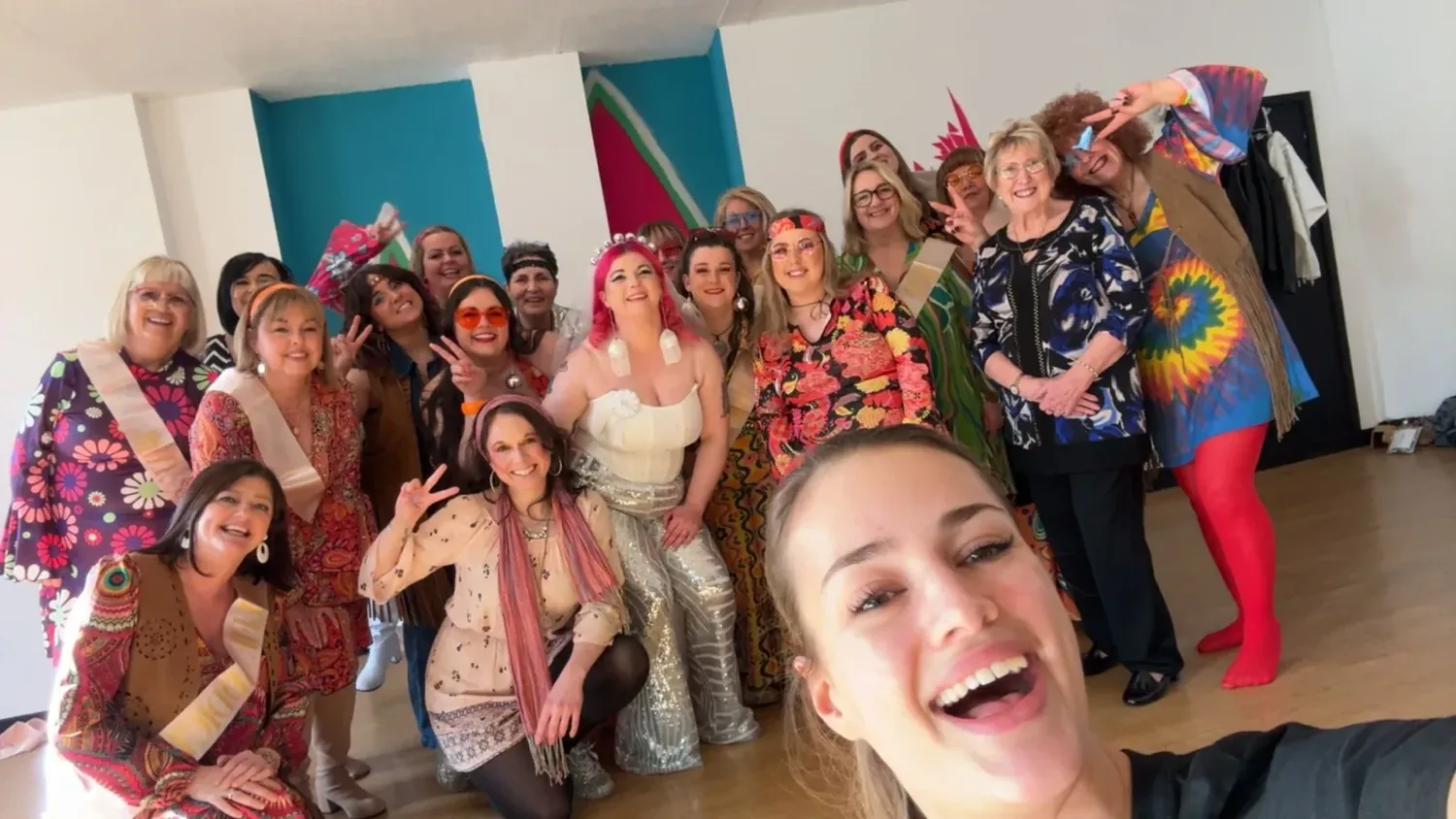 ABBA hen party dance class in Chester, group in 70s outfits mid-celebration